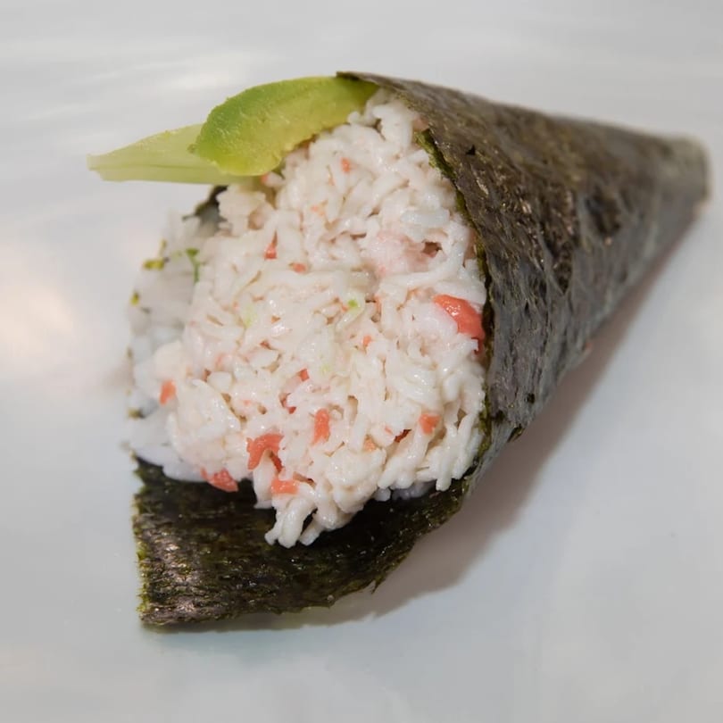 A hand roll from Jimmy's Poke & Sushi Burrito, filled with white rice, crab, and avocado.