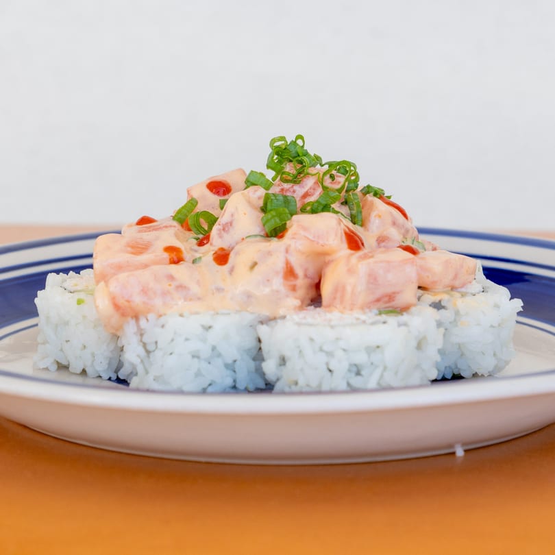 Jimmy's Poke & Sushi Burrito's sushi rolls topped with creamy salmon poke and green onions.